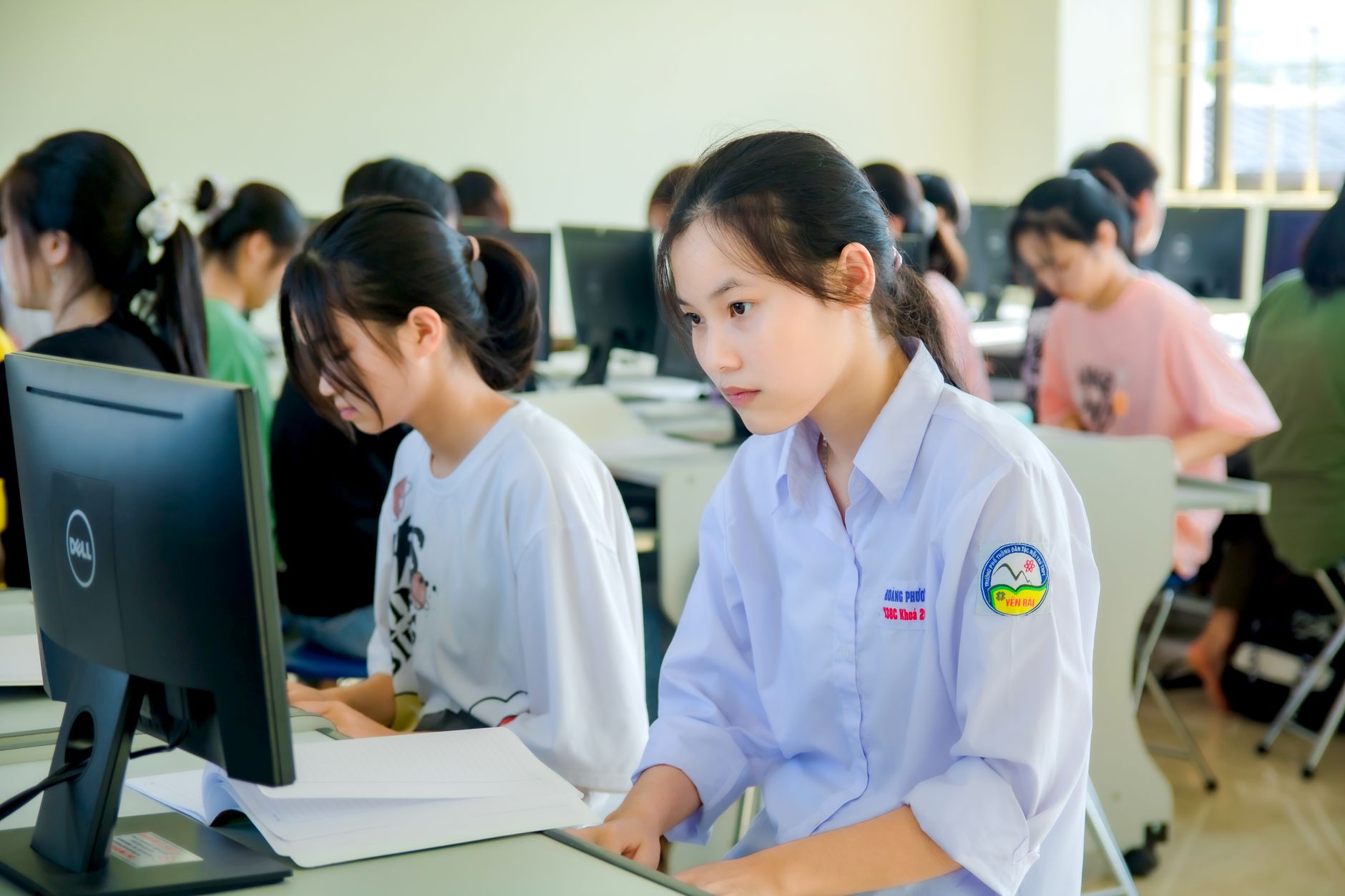 Students focused on computer screens in a classroom