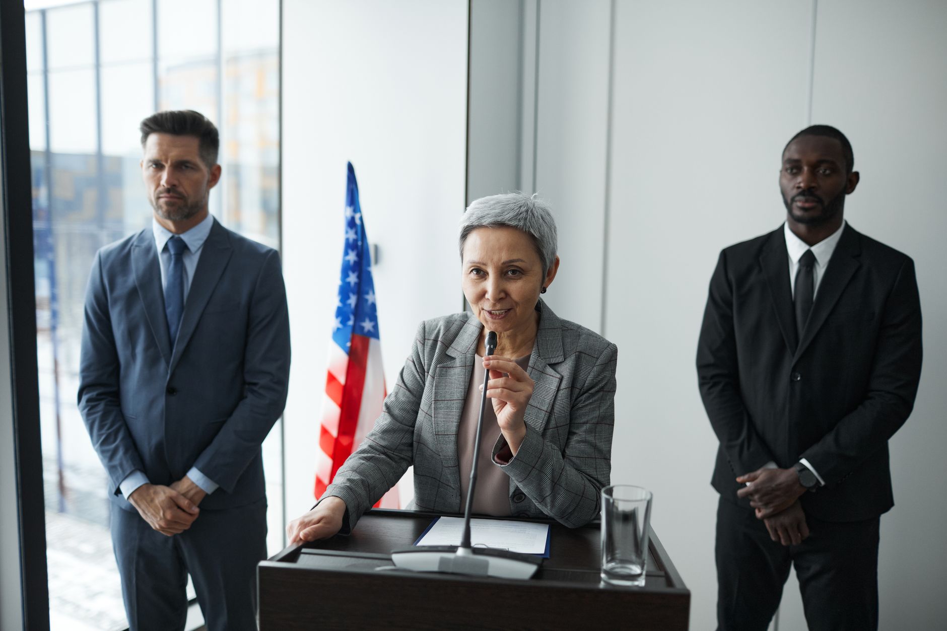 Politician speaking with an American flag in the background
